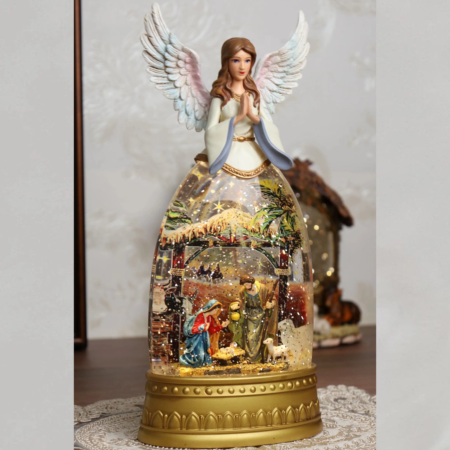 Gold-toned nativity snow globe with detailed resin figures and lighting