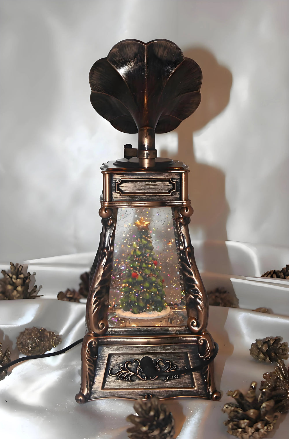 Snow globe decoration in phonograph style placed on mantel for vintage Christmas ambiance.