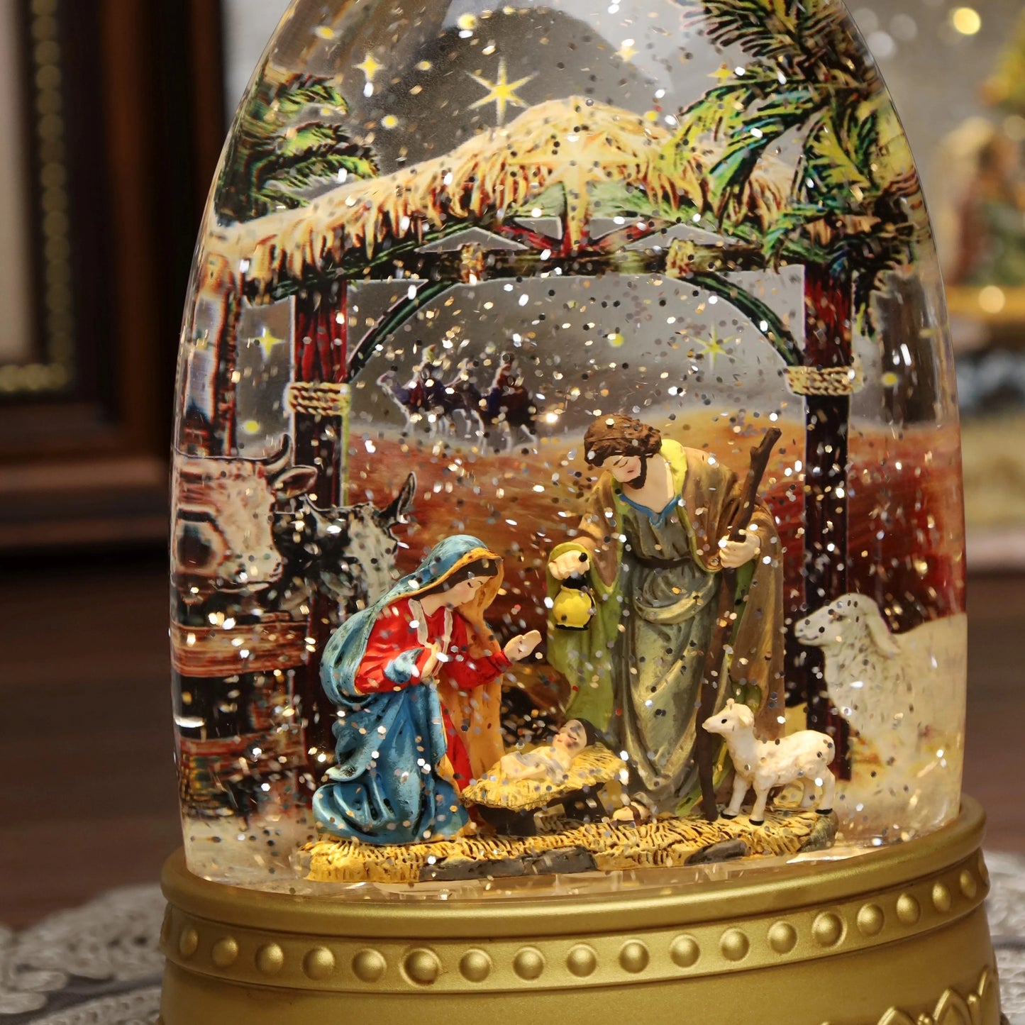 Religious Christmas snow globe featuring the Holy Family inside clear globe