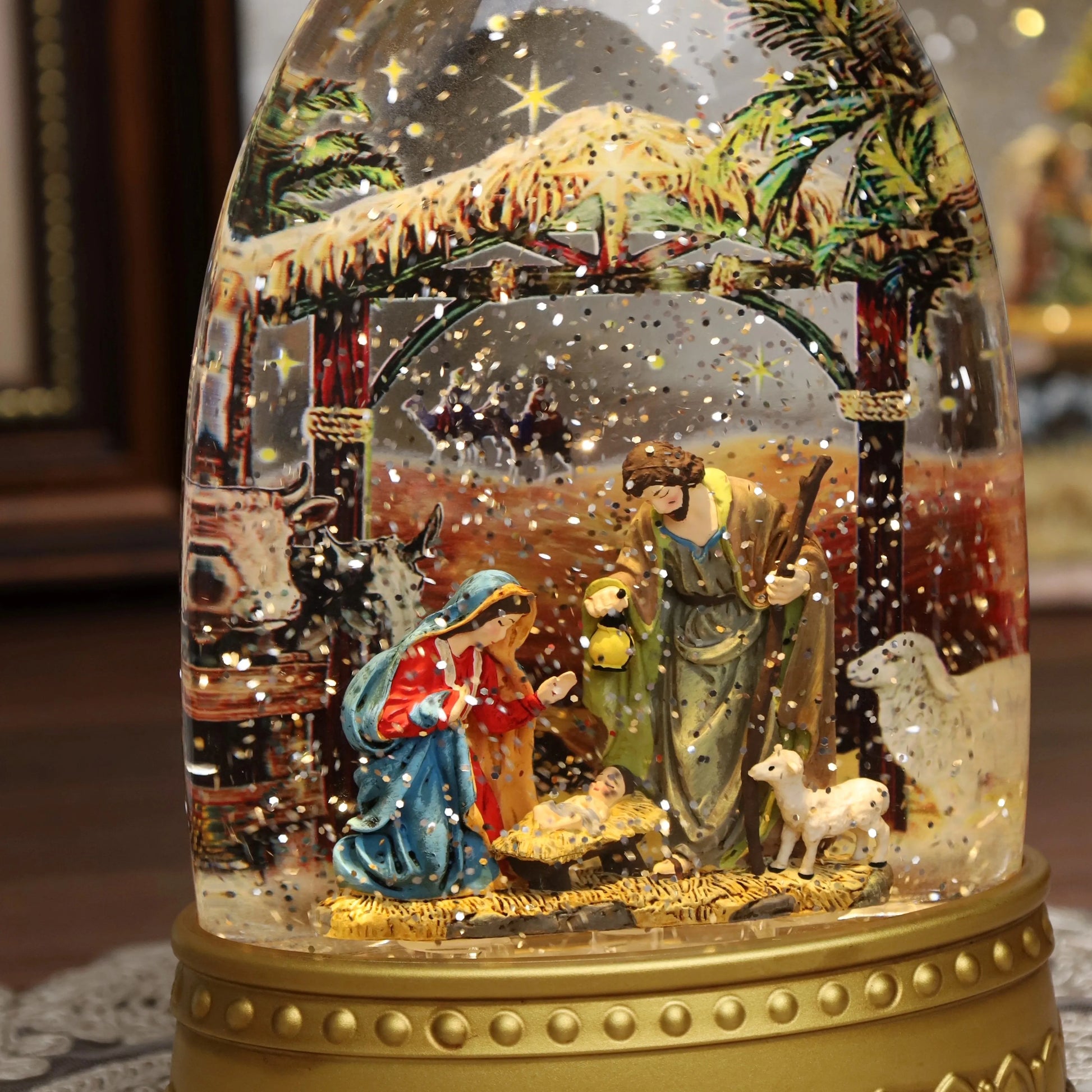 Religious Christmas snow globe featuring the Holy Family inside clear globe