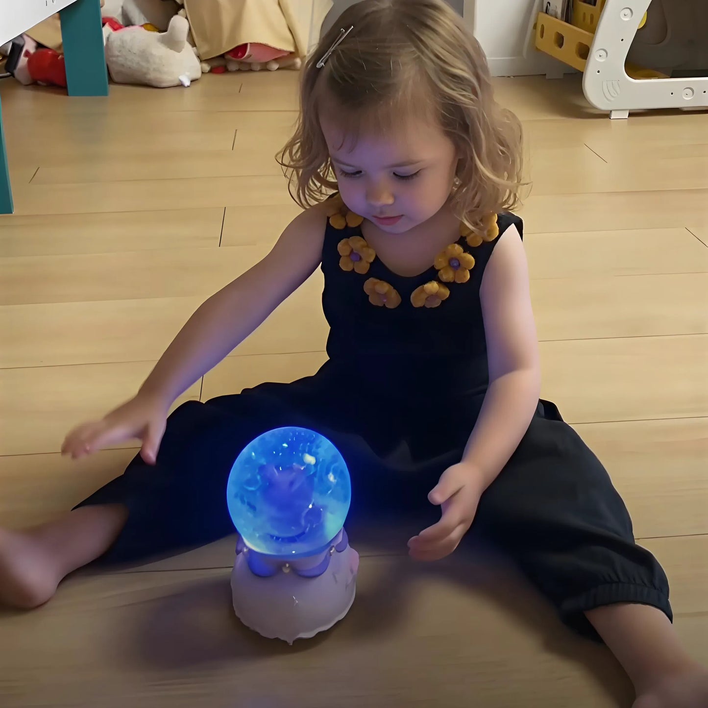 Light-up rabbit music box glowing at night with warm LED and swirling snow.