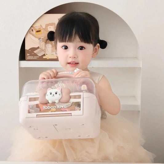 Child holding a transparent toy box with a cat design, sitting in a white room.
