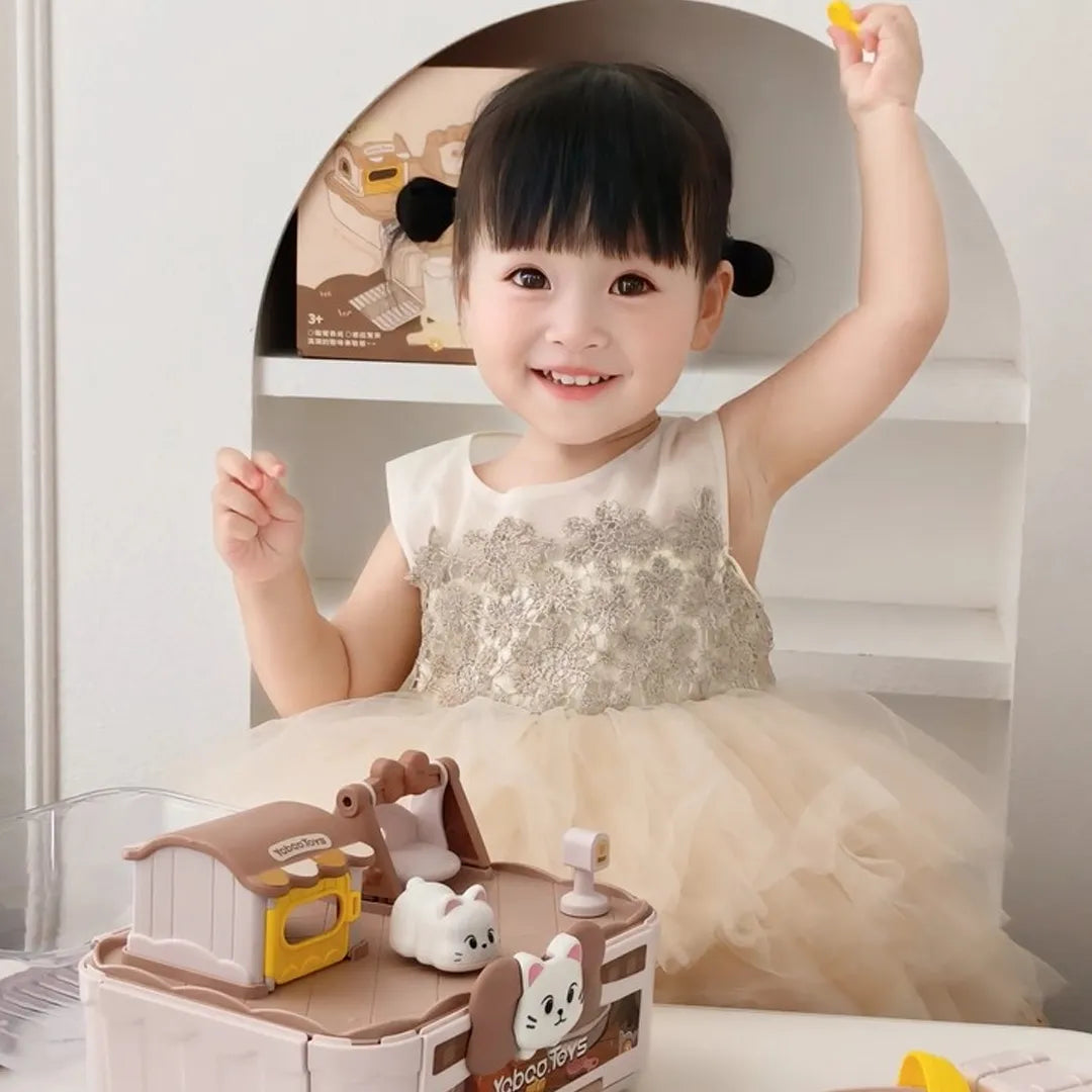 Child in a white dress with a toy set on a white background