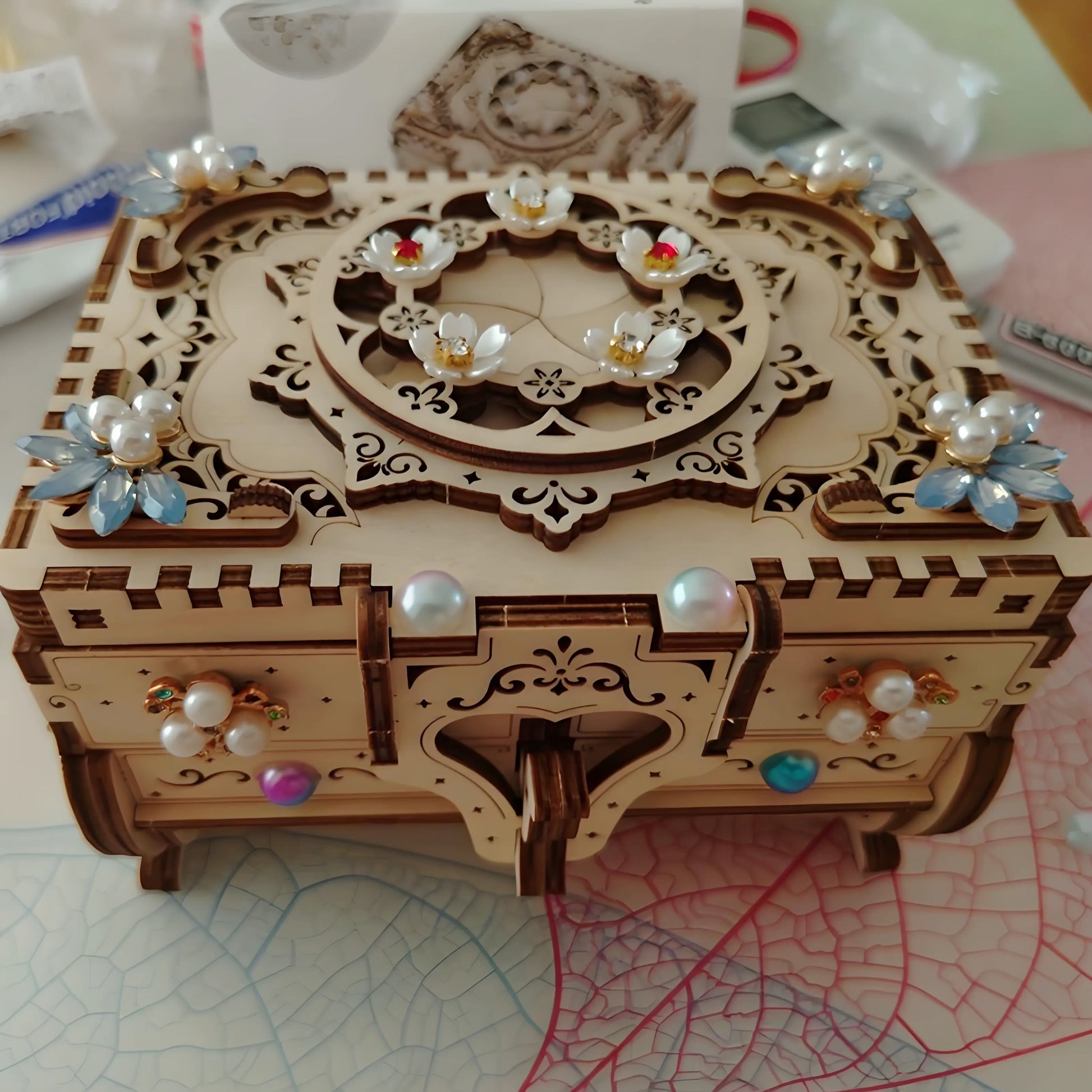DIY Mechanical Music Box Puzzle Jewelry Box made of laser-cut linden wood, showing hidden compartments and spring-powered 18-note music movement, perfect for DIY craft lovers and gift-giving.
