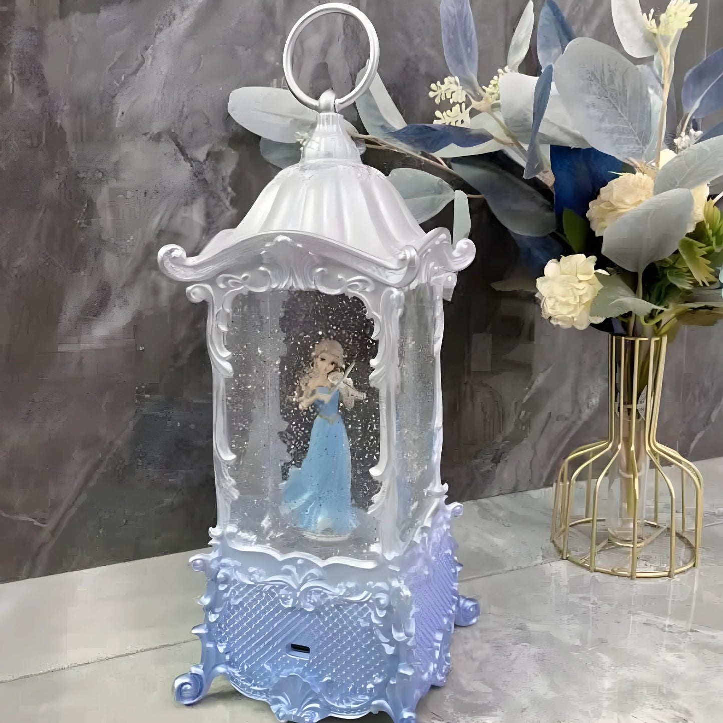 Holiday décor display featuring the glowing princess snow globe lantern
