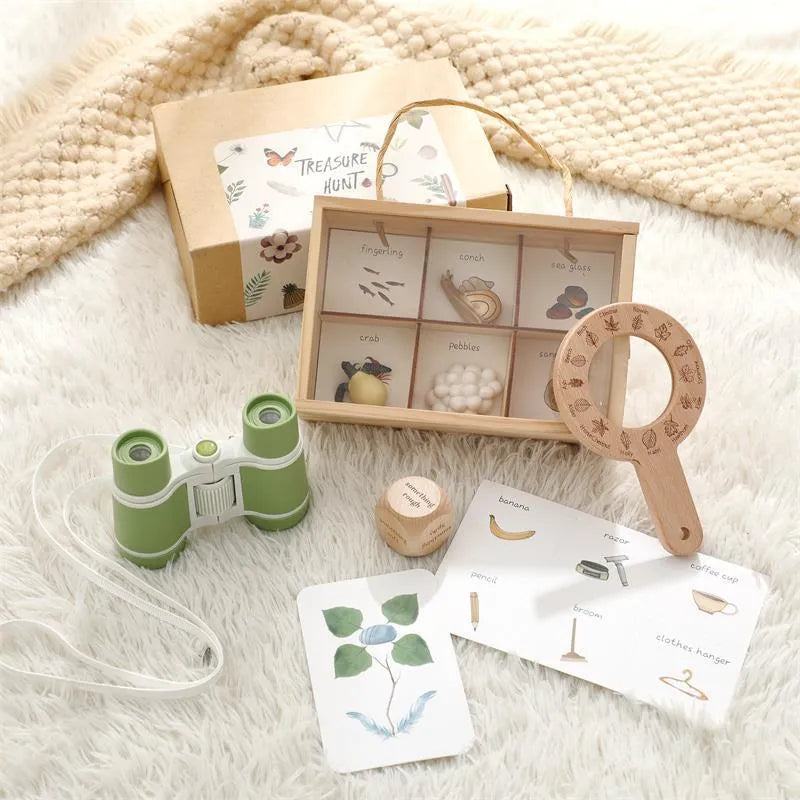 Educational toy set with wooden box, binoculars, cards, and a wooden tool on a soft surface.