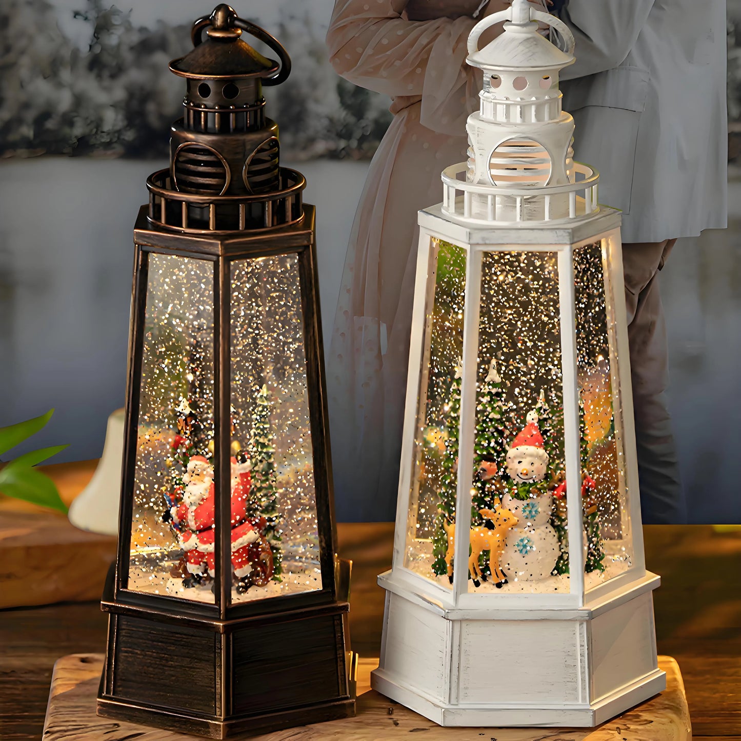 Illuminated musical snow globe lantern serving as a Christmas centerpiece on a holiday dining table. The warm white LED light projects dancing water reflections and sparkling glitter patterns on the surrounding decor, creating a cozy festive ambiance.