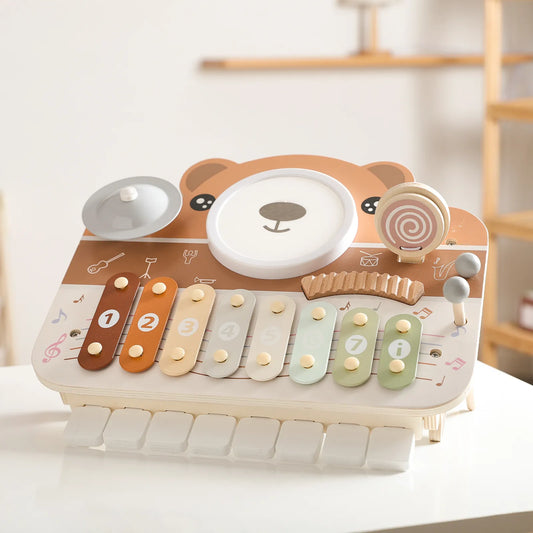 Montessori musical toy with drum, piano, and xylophone visible