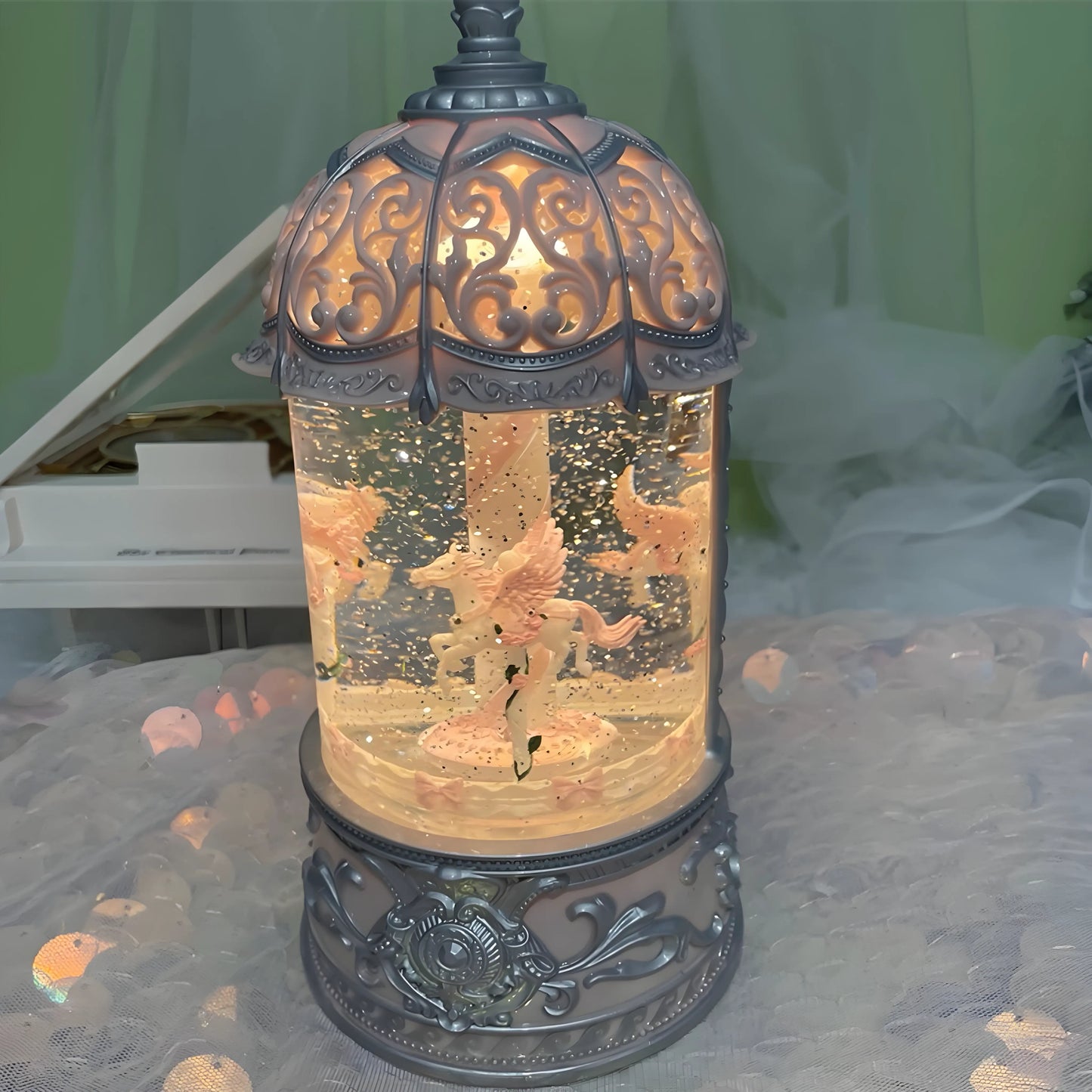 Close-up of pink carousel snow globe showing rotating horses and snowflakes