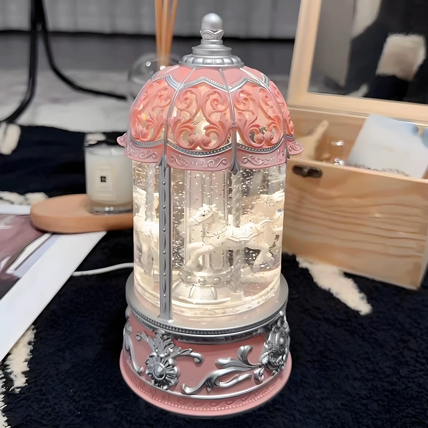 Festive pink and silver snow globe carousel for Christmas and winter gifts