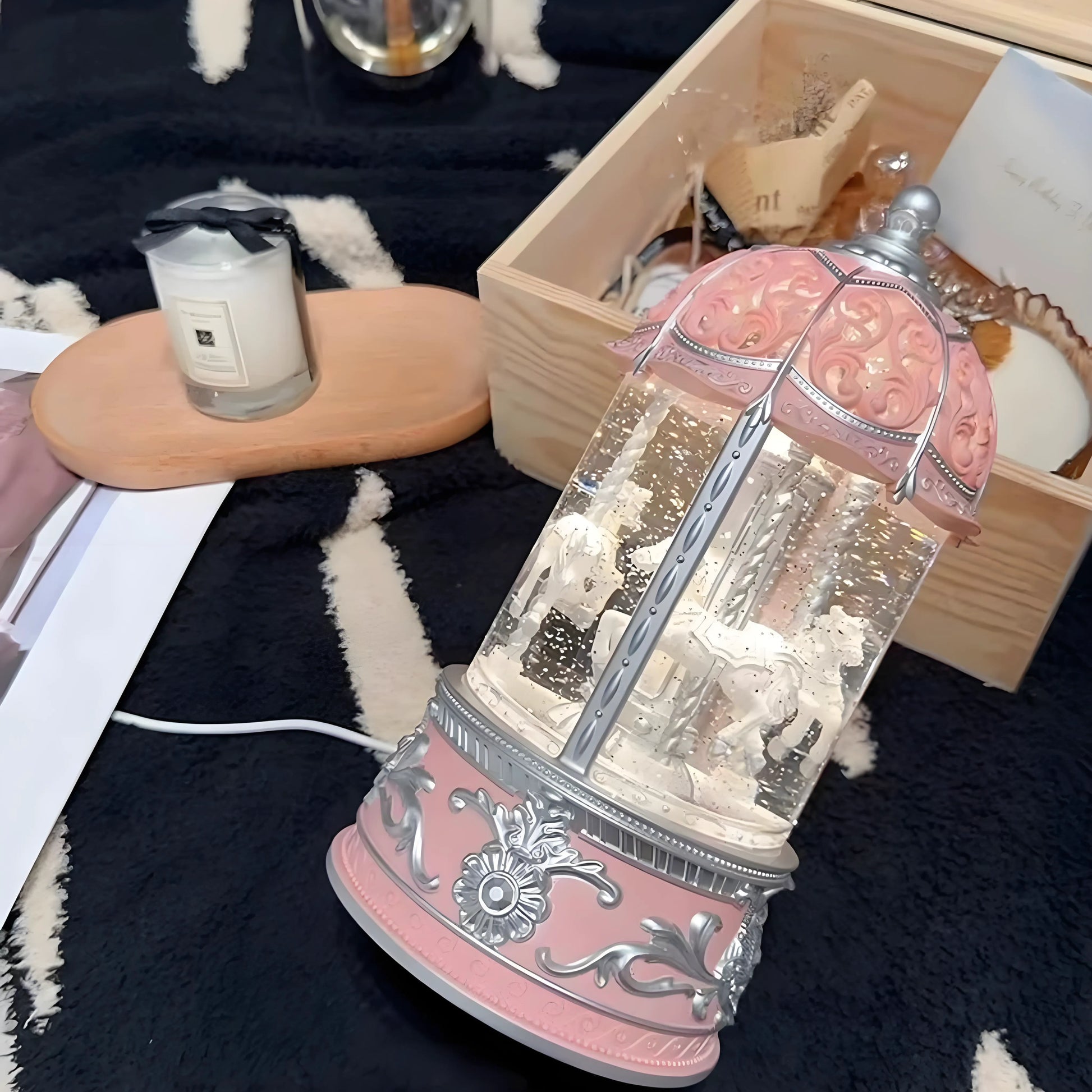 Christmas snow globe featuring pink carousel, snow swirl effect, and LED lights
