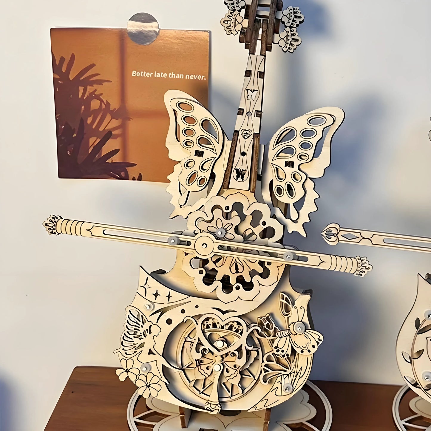 Finished wooden cello music box displayed on shelf – elegant home décor and craft project