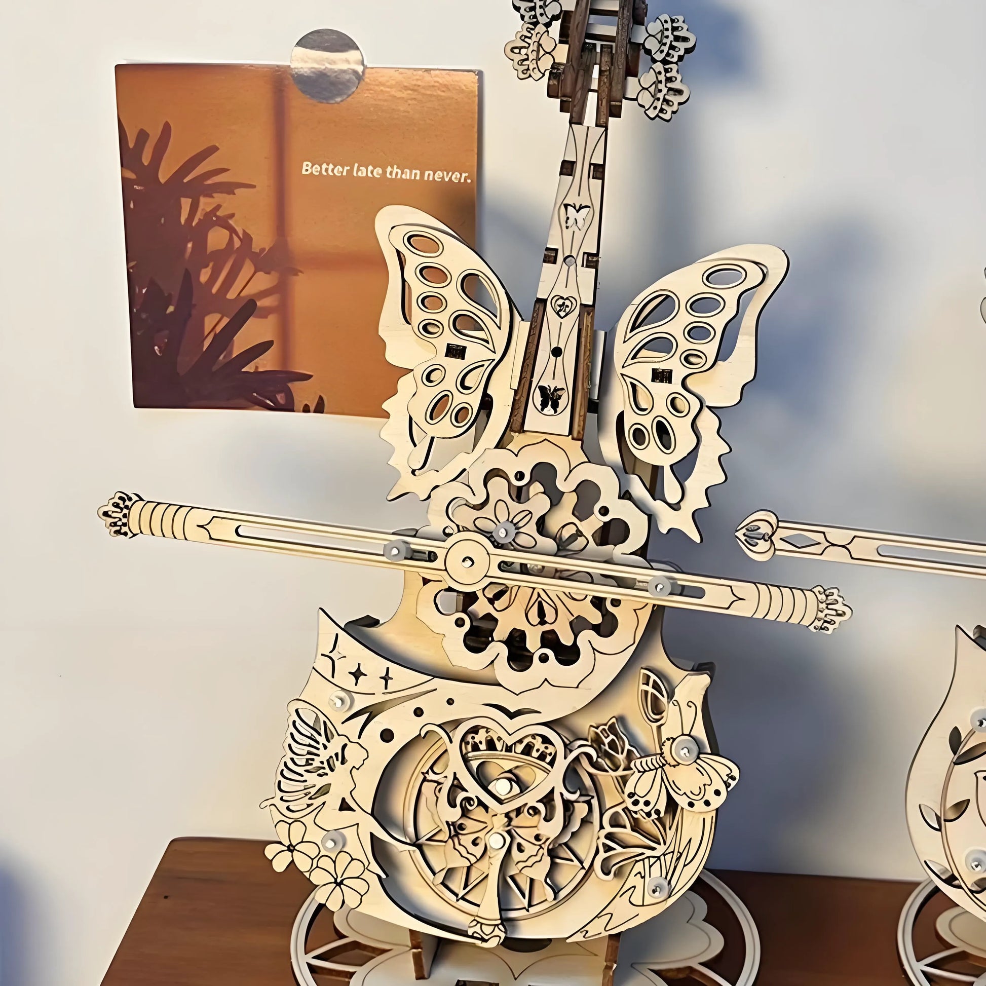 Finished wooden cello music box displayed on shelf – elegant home décor and craft project