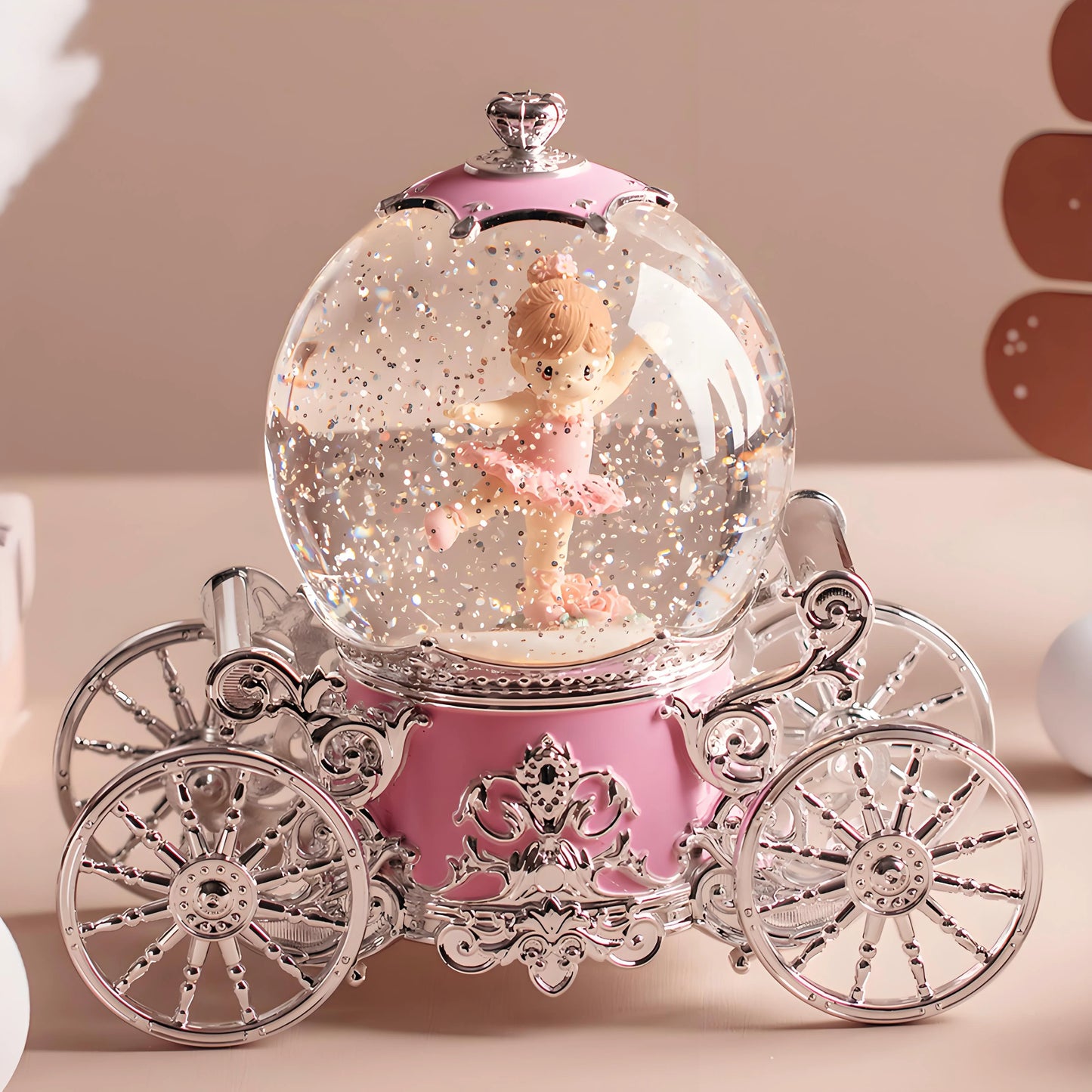 Musical snow globe pumpkin carriage shown in natural light highlighting clear globe transparency