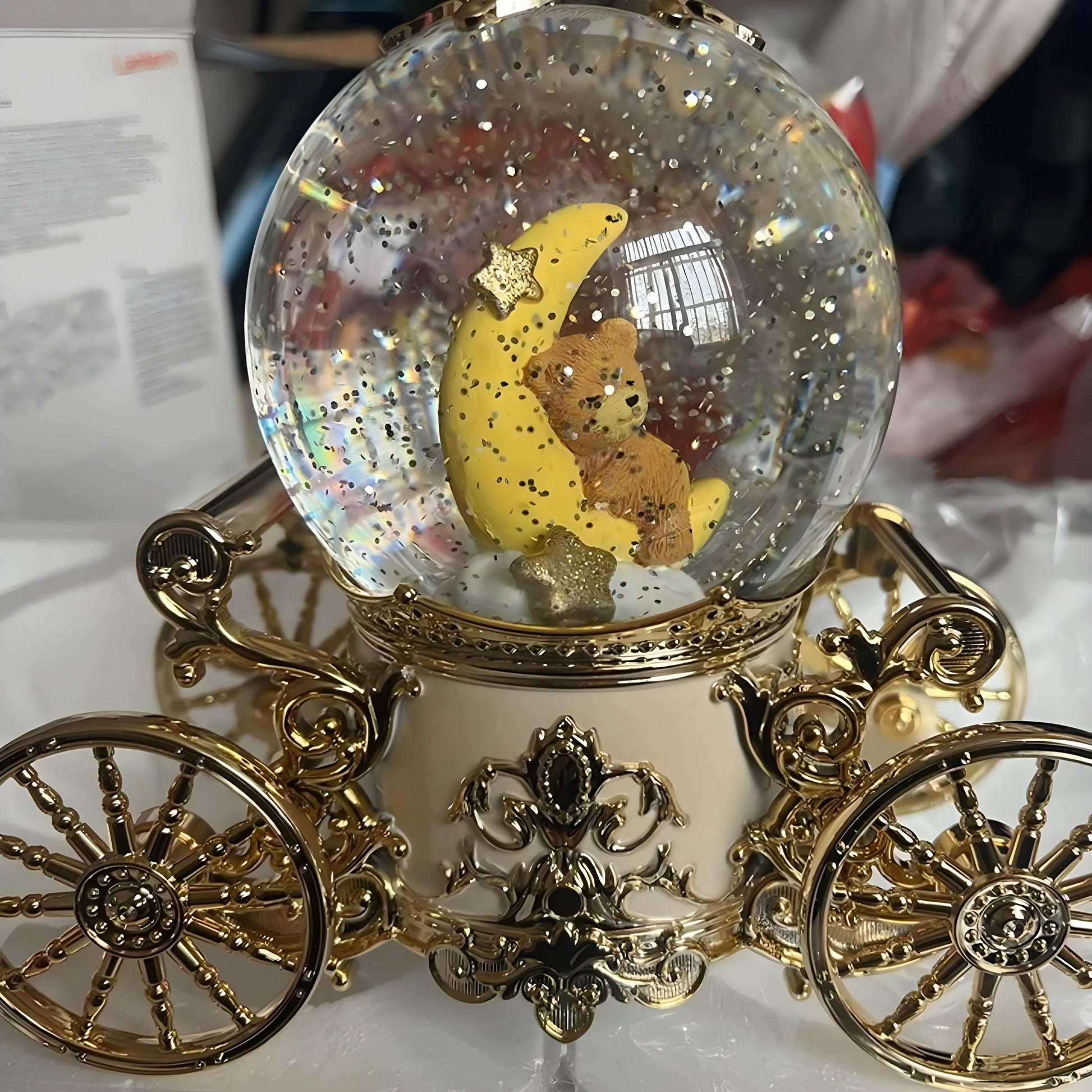 Close-up view of pumpkin carriage snow globe structure, resin body and smooth rotating wheels