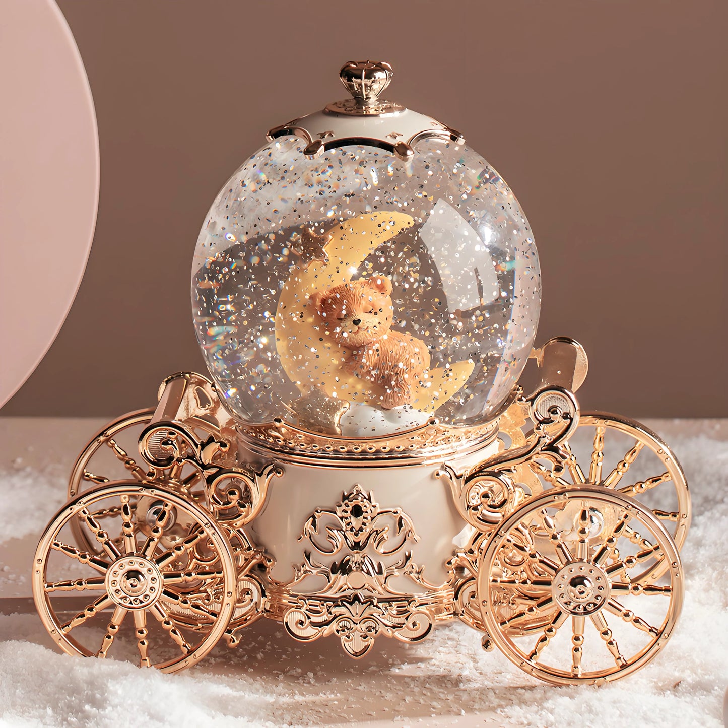 Musical snow globe pumpkin carriage shown in real-life home décor setting on shelf