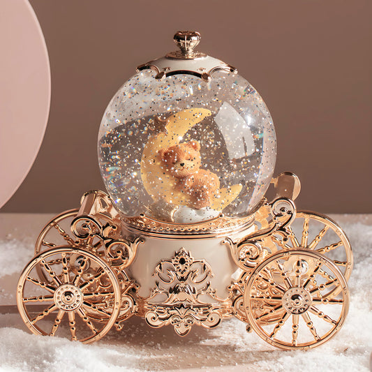 Musical snow globe pumpkin carriage shown in real-life home décor setting on shelf