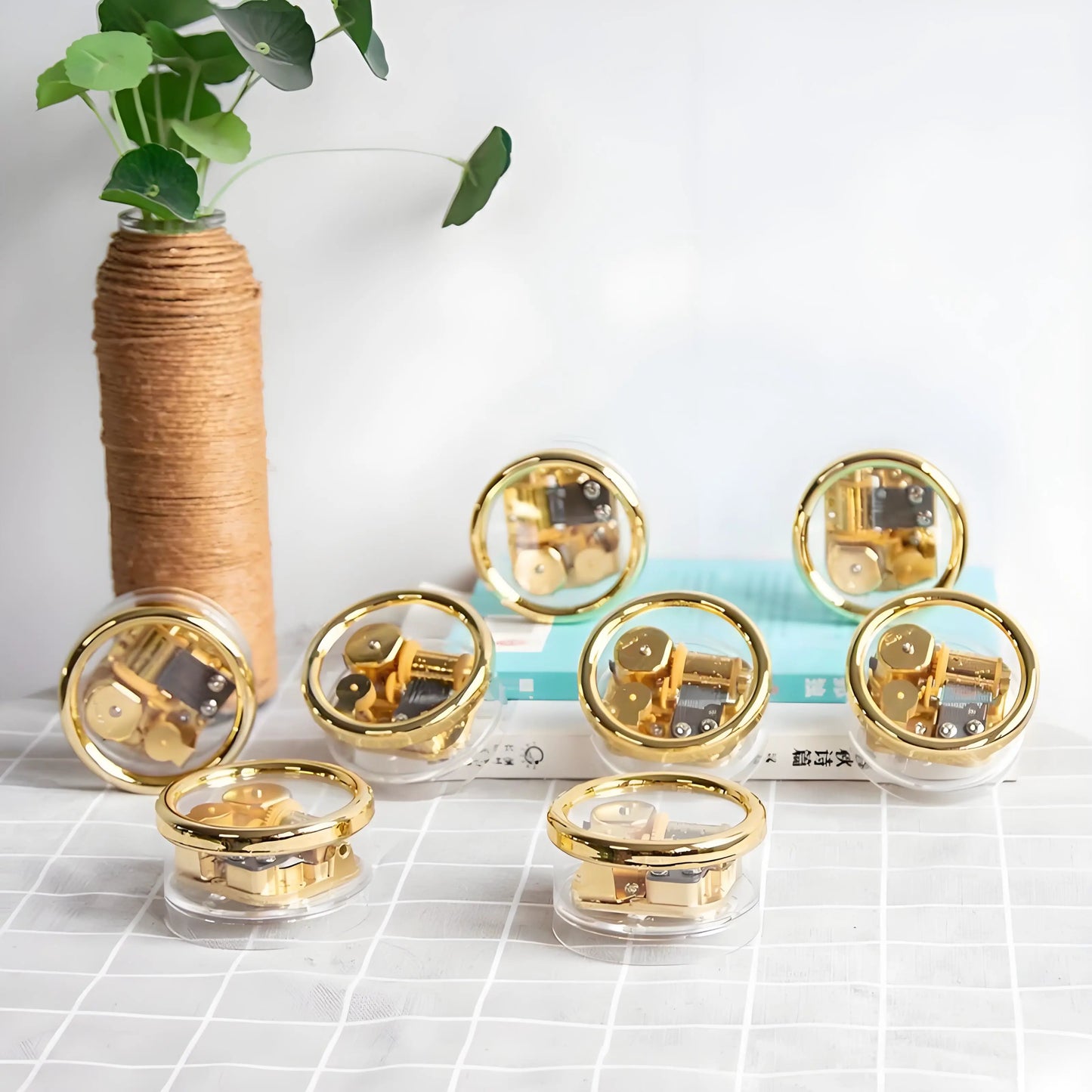 Small retro wind-up music box, transparent case revealing gears and golden metal movement