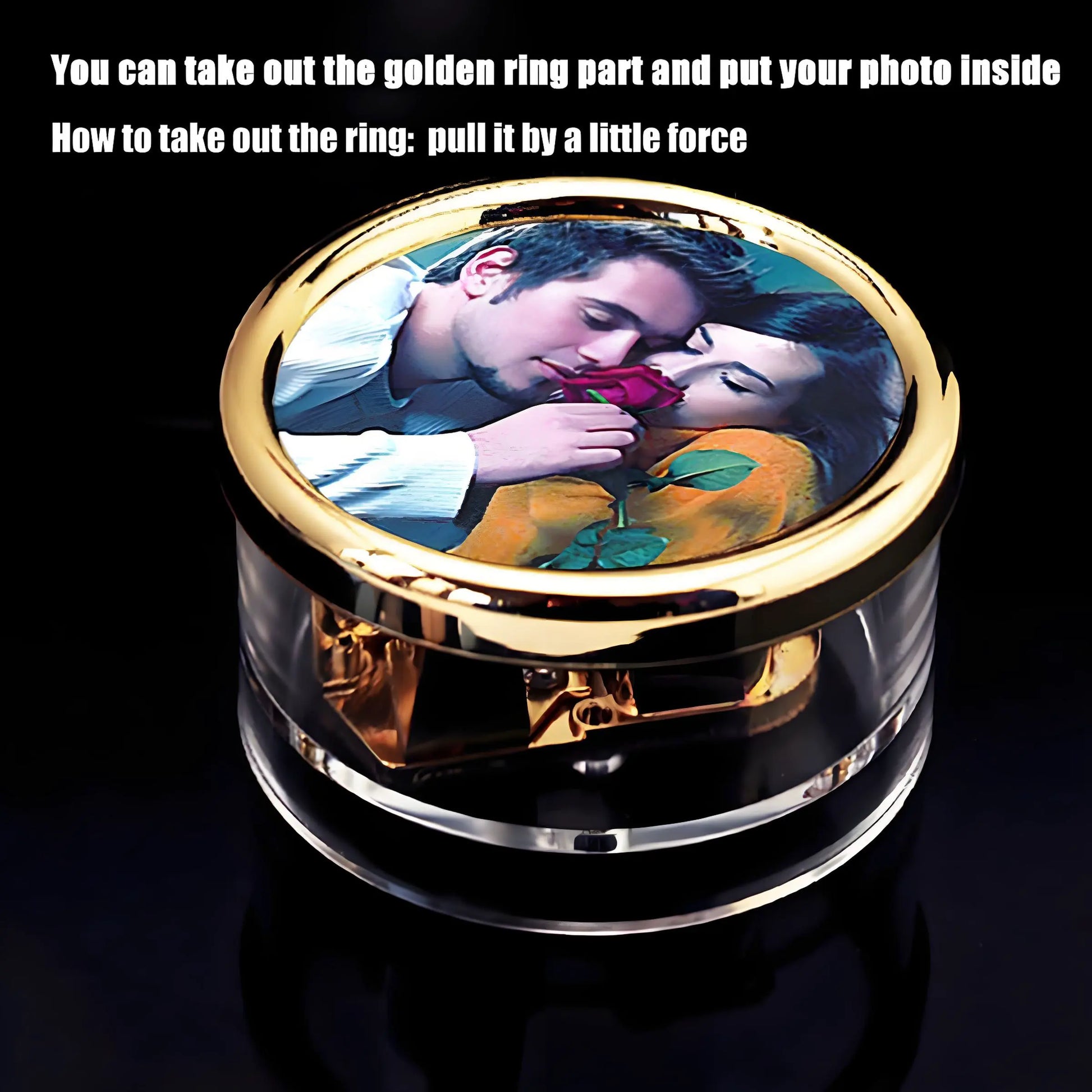 Compact vintage style wind-up music box, transparent body, visible golden clockwork mechanism