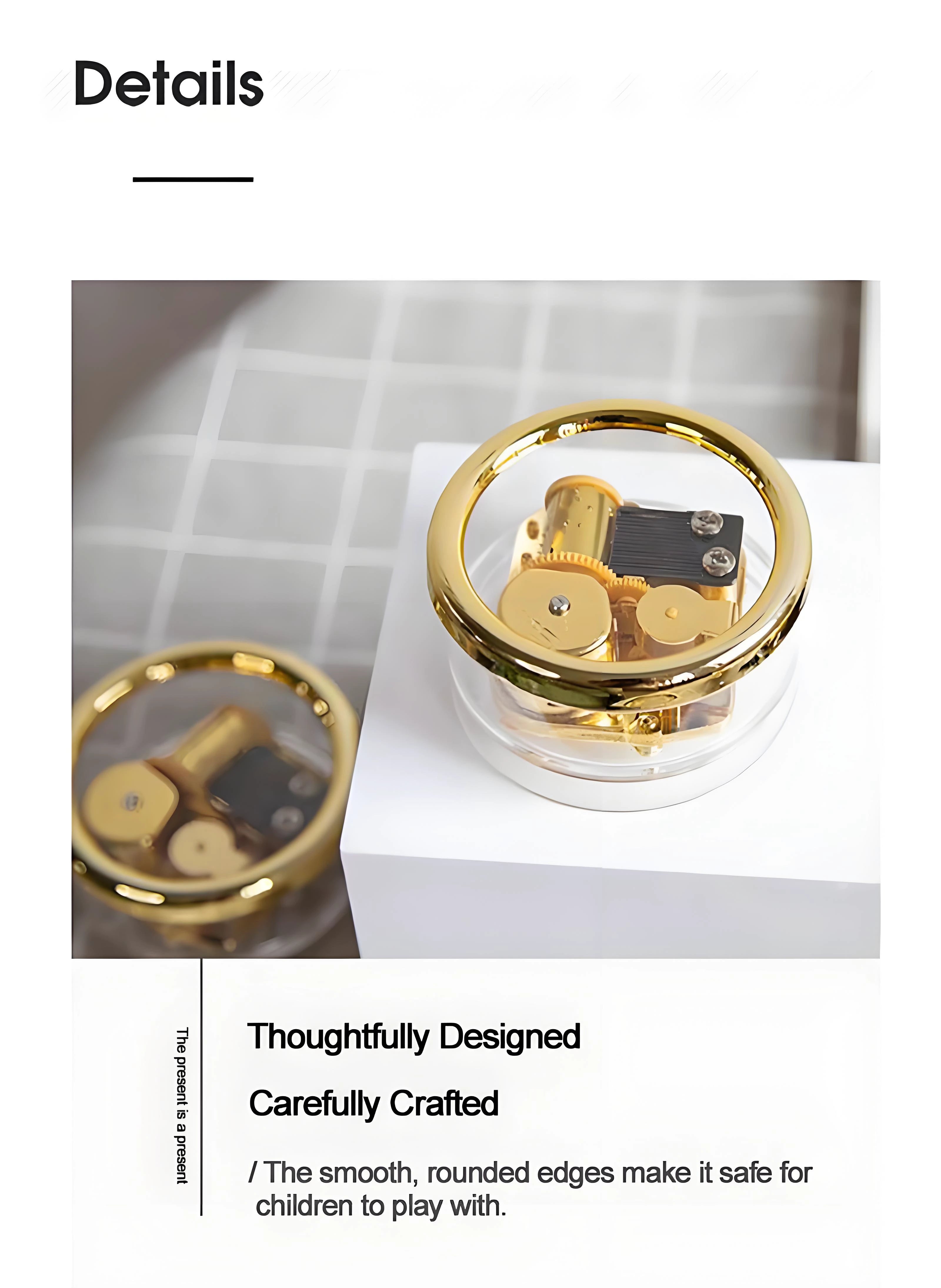 Small retro wind-up music box, transparent case revealing gears and golden metal movement